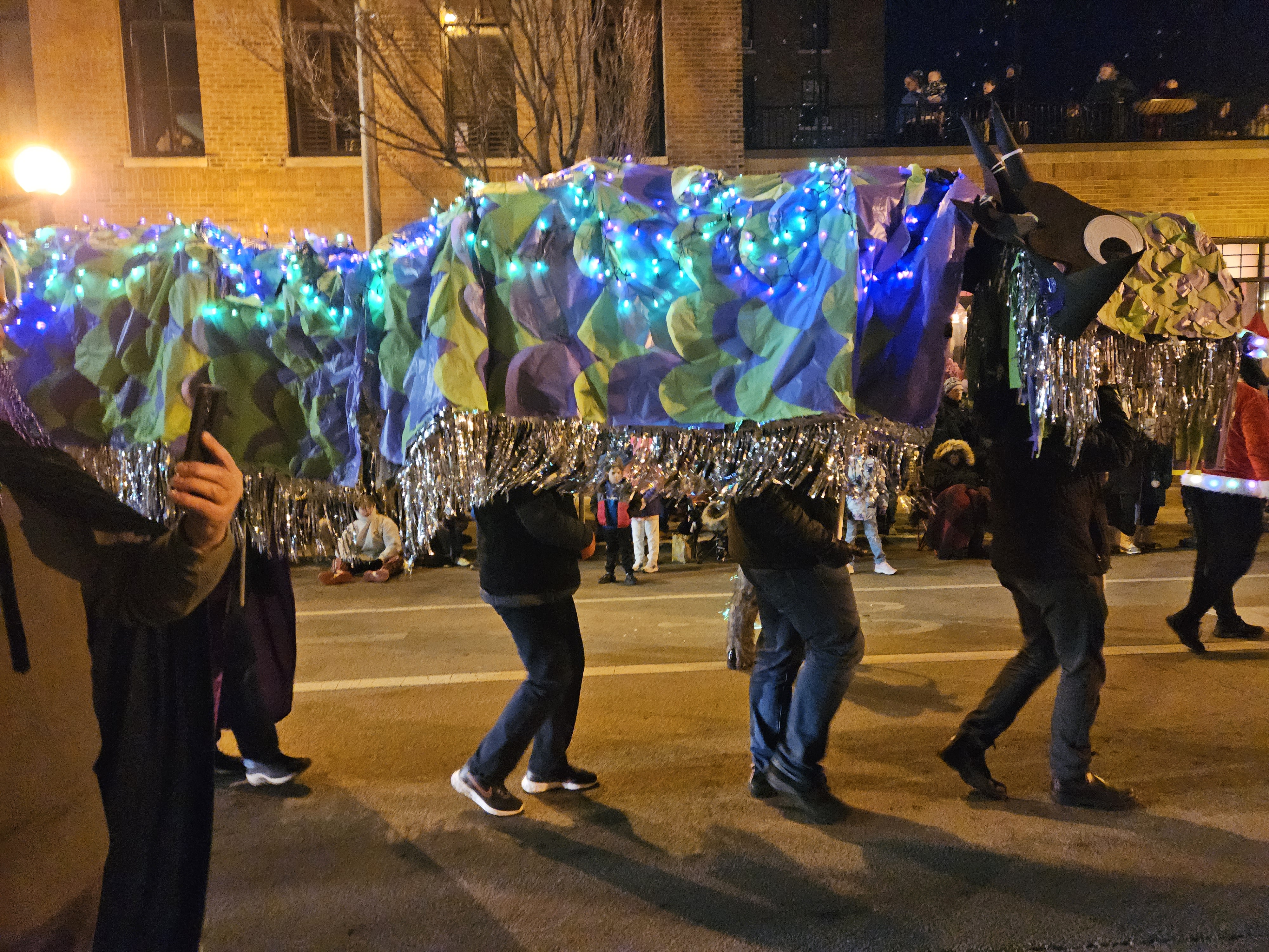 The first dragon entry — lit up at night in the Parade of Lights